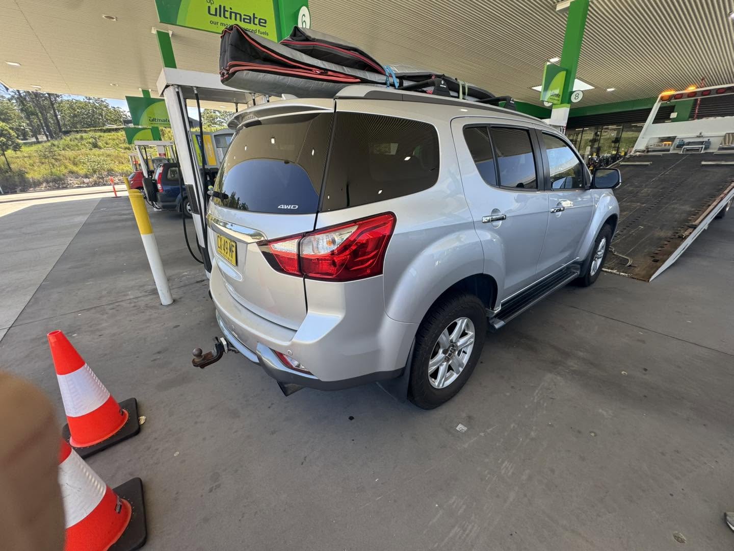Silver 4WD with a flat battery waiting for a Clarence Valley Tow Trucks roadside assistance callout at a service station