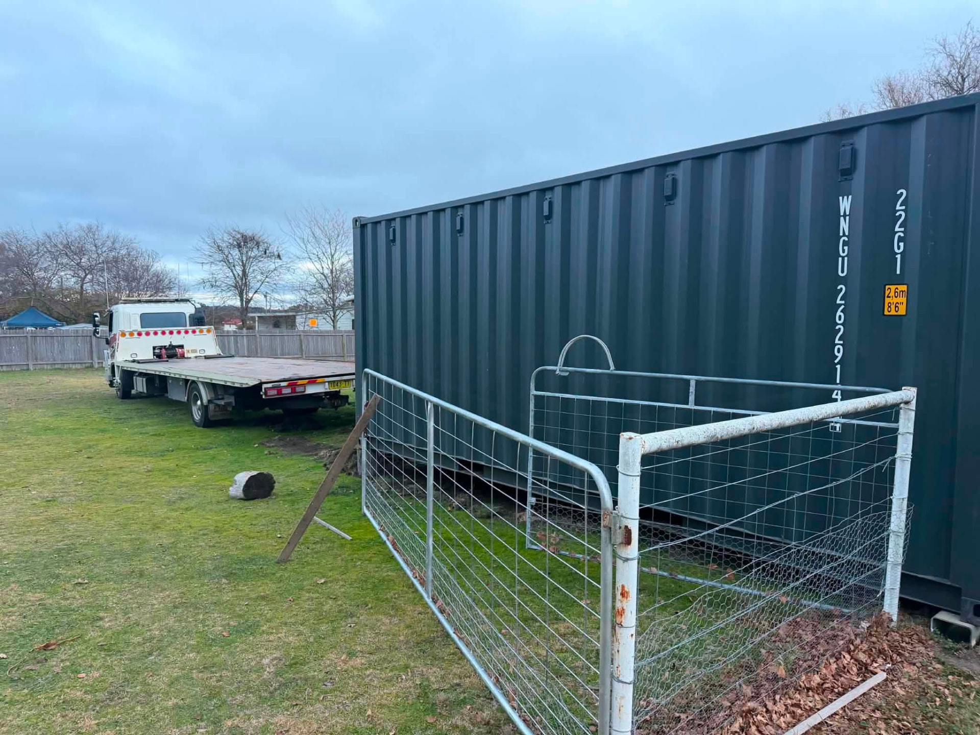 Shipping container placed on site with a Clarence Valley Tow Trucks tilt tray in the yard behind