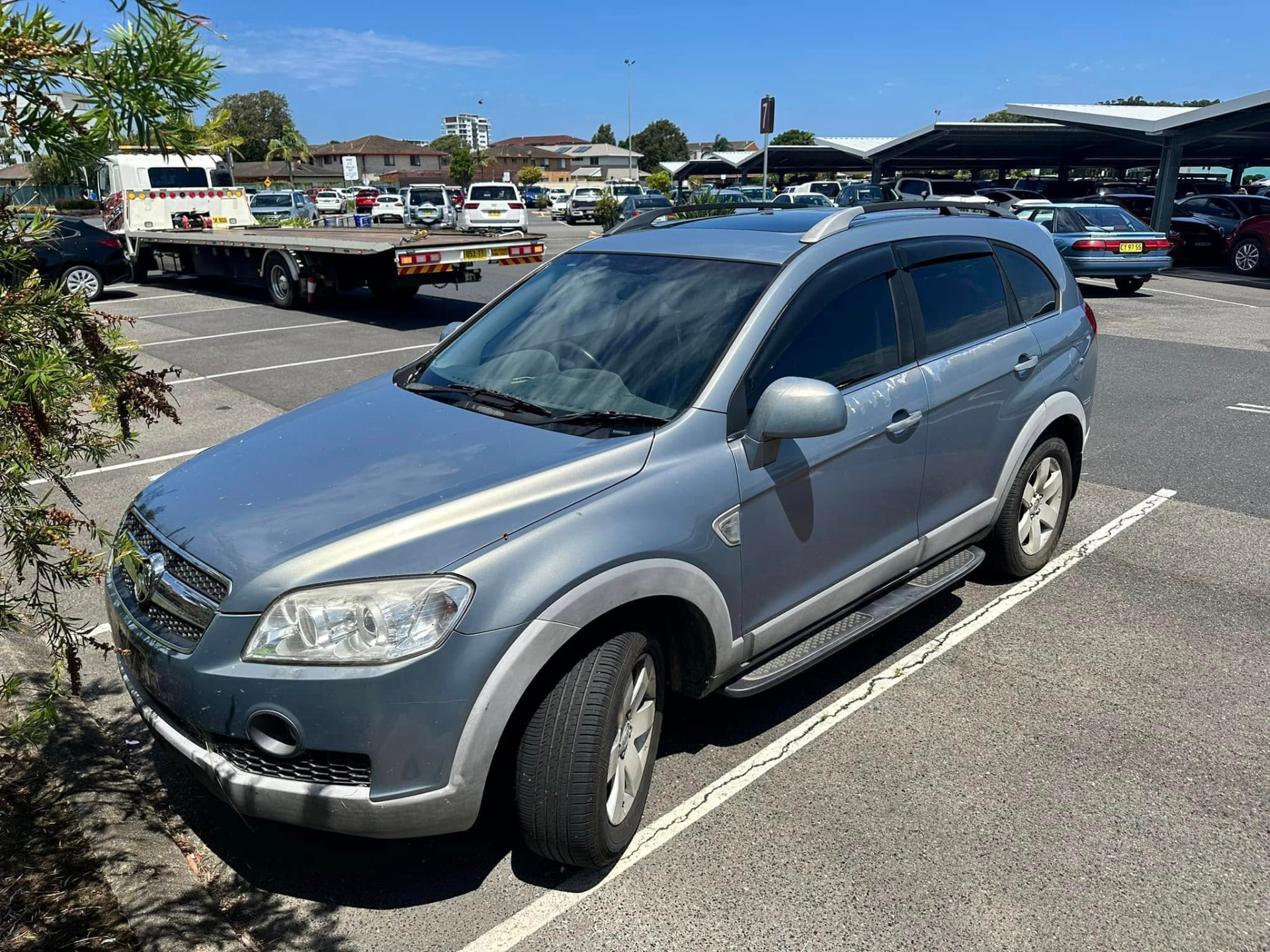 Silver SUV in a Grafton car park with a Clarence Valley Tow Trucks tilt tray on a roadside assistance callout