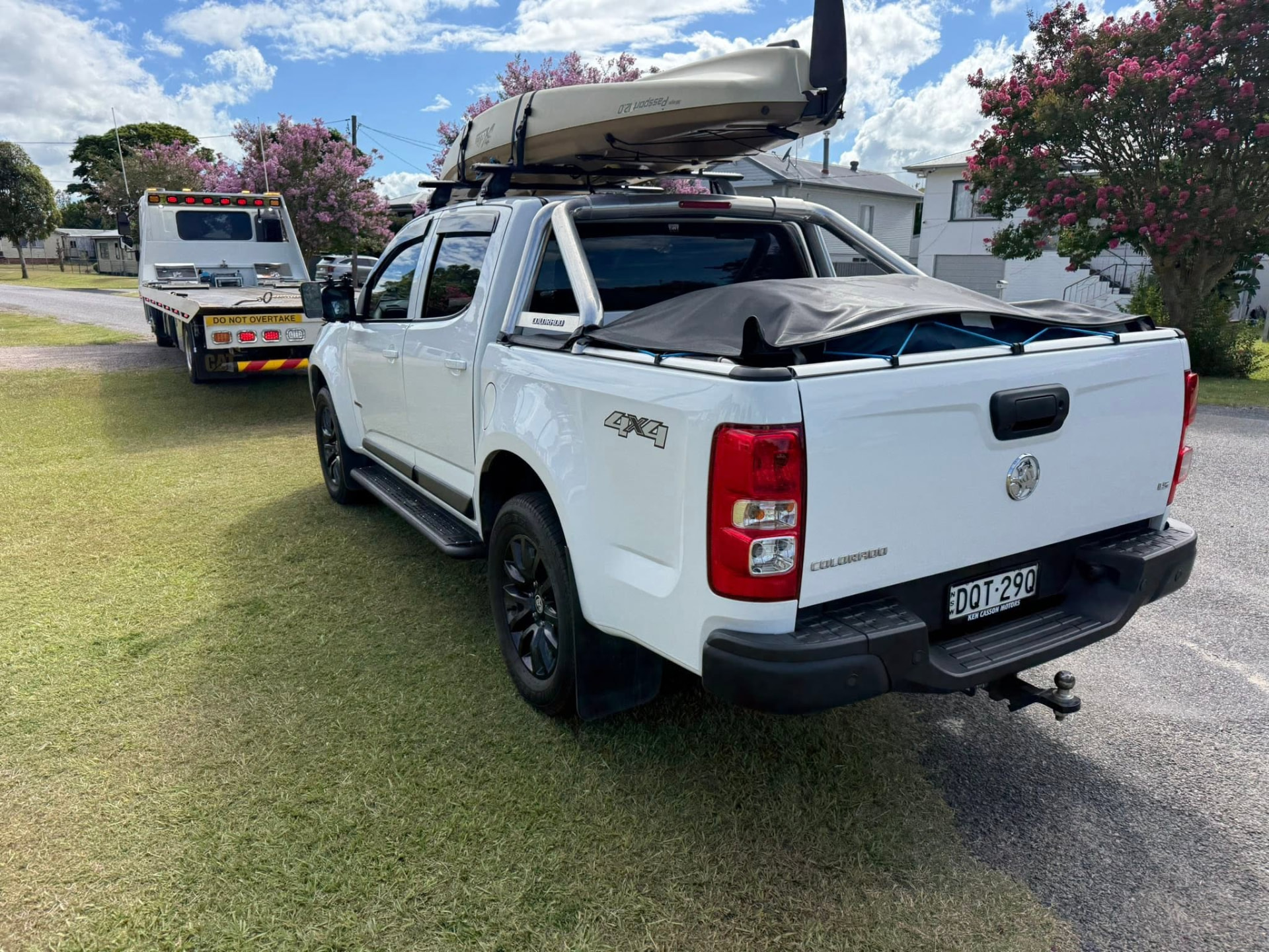 White ute out of fuel with a Clarence Valley Tow Trucks tilt tray arriving for a roadside fuel delivery