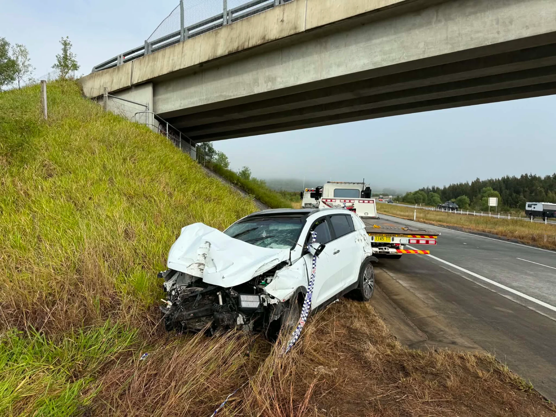 Crashed vehicle being recovered from the roadside near Grafton
